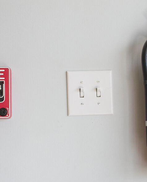 a fire alarm pull box and fire extinguisher